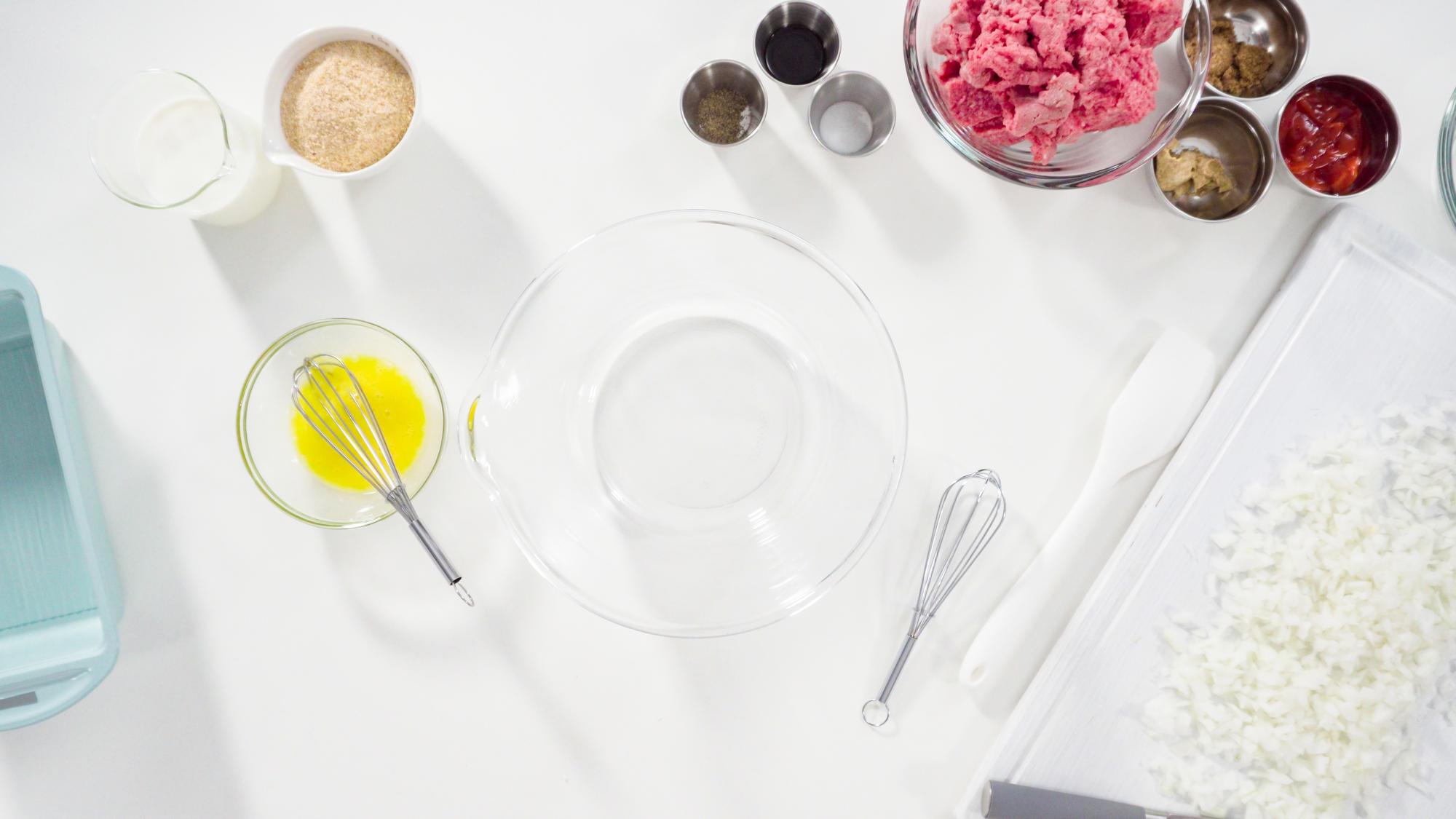 Wide shot of workshop table with ingredients and plated courses